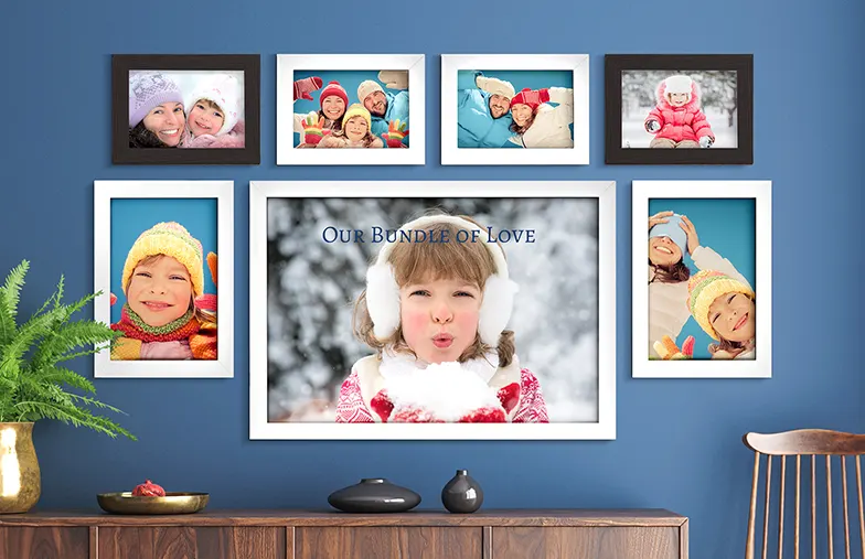 Personalised family photo wall display: cherished moments in stylish white & dark frames, showcasing winter fun & family love.
